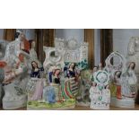 A COLLECTION OF STAFFORDSHIRE FLAT BACK FIGURES decorated with clocks and two pocket watch stands (