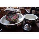 AN EDWARDIAN WASHSTAND SET with flowers and birds on a black ground