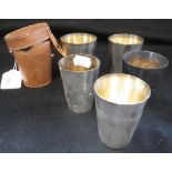 ASPREY & CO: A SET OF GRADUATED SILVER PLATED BEAKERS, with gilt-washed interiors, fitted in a tan