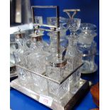 AN ART DECO SILVER PLATED SIX BOTTLE CRUET of geometrical design and two pickle jars in a silver