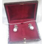 A PAIR OF GREY TONE PEARL DROP EARRINGS with diamond set bow surmounts, in a presentation case