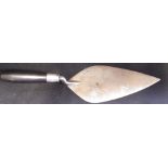 A BRICKLAYER'S CEREMONIAL SILVER TROWEL with wooden handle