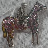 A SILVER ENAMEL MARCASITE JOCKEY AND HORSE PENDANT BROOCH, 3.5cm x 3cm