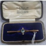 AN AQUAMARINE AND SEED PEARL BAR BROOCH, stamped 9ct, in a fitted presentation case