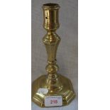 A QUEEN ANNE BRASS SINGLE CANDLESTICK, tapering knopped stem with urn capital, on an octagonal base,