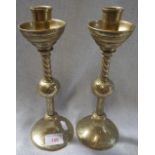 A PAIR OF GOTHIC REVIVAL BRASS CANDLESTICKS with engraved decoration and spiral column, 28cm high