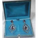 A PAIR OF DROP EARRINGS stamped 585, (14ct) and 925 ( silver) set with garnets and diamonds in a