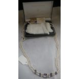 A DOUBLE STRAND CULTURED PEARL NECKLACE with amethyst clasp