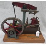 STUART; A WORKING SCALE MODEL OF A FULL BEAM STEAM ENGINE in red and brown on an oak plinth, 33cm