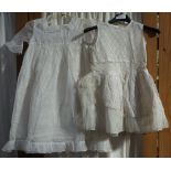 A CHILD'S WHITE NET VINTAGE PARTY DRESS and another similar decorated with spots and white