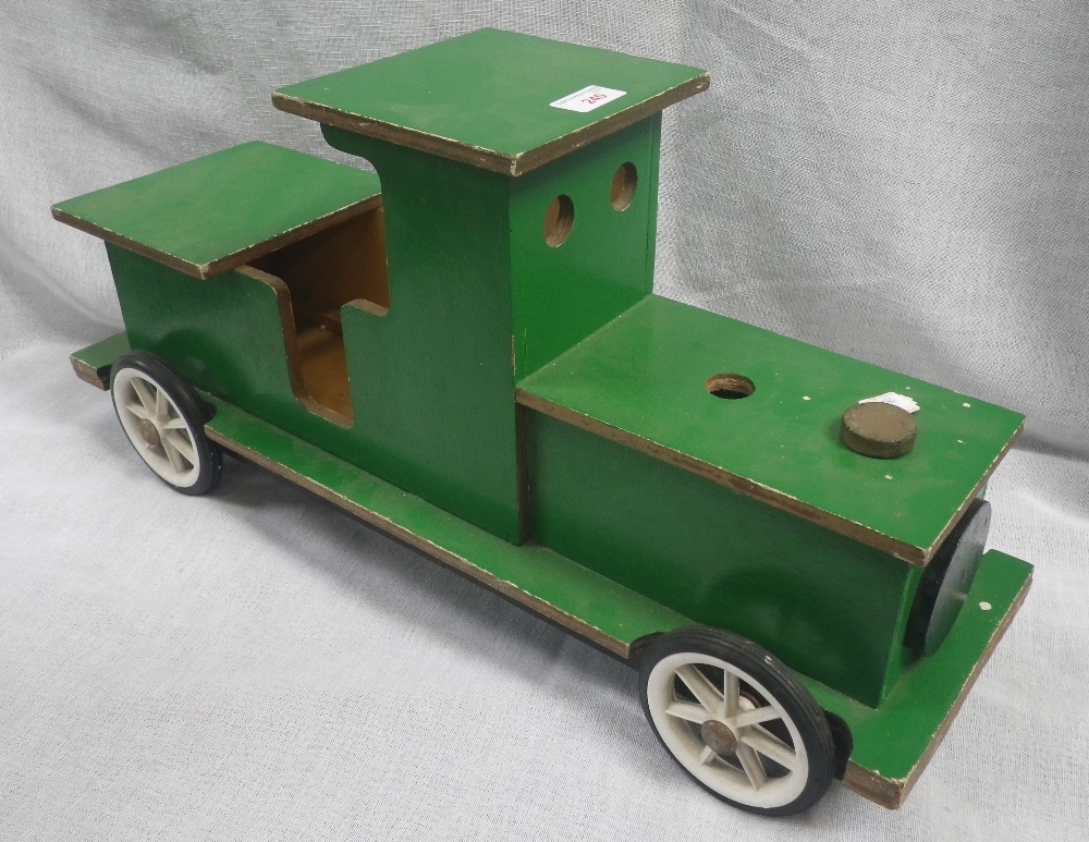 A GREEN PAINTED WOODEN CHILD'S SIT AND RIDE TRAIN