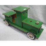 A GREEN PAINTED WOODEN CHILD'S SIT AND RIDE TRAIN