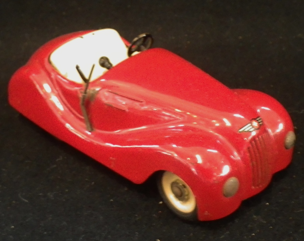 JIBBY; A VINTAGE TINPLATE CLOCKWORK OPEN CAR in red, made in Switzerland