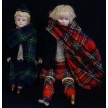 AN 1880'S GERMAN BISQUE DOLL of a Scottish boy in tartan, 30cm high and another
