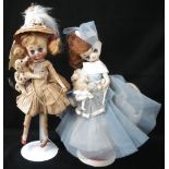 A VINTAGE 'COOKIE' FABRIC DOLL carrying a dog and another similar (2)