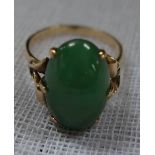 A "JADEITE" DRESS RING, on a yellow gold shank, stamped "14K", ring size P