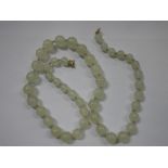 A GRADUATED PALE GREEN JADEITE NECKLACE, with ring clasp, 63cm long