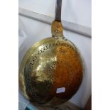 A 17TH CENTURY ENGRAVED BRASS WARMING PAN, the steel handle with initials