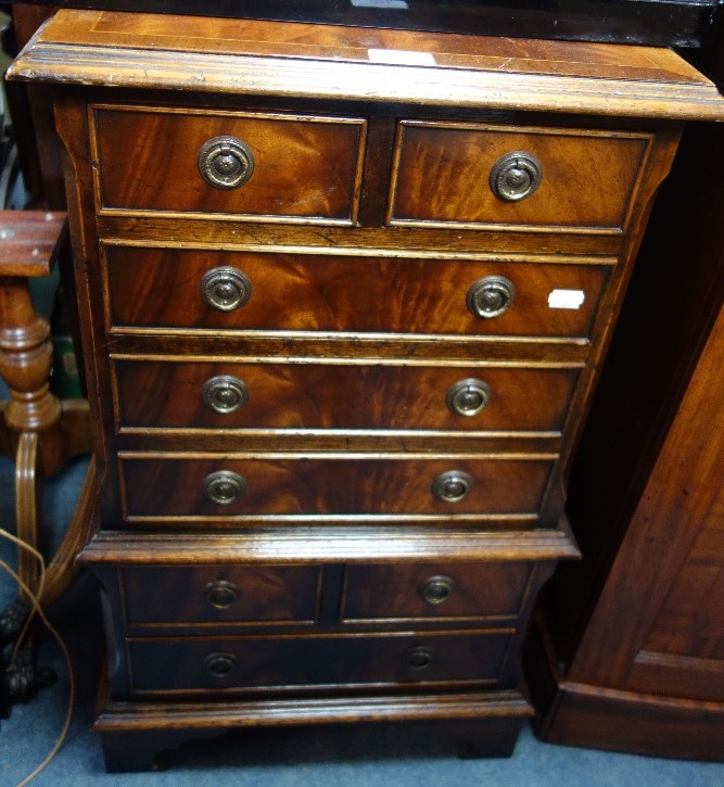 A REPRODUCTION MAHOGANY CHEST ON CHEST of small proportions, 43cm wide and a collection of