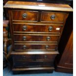 A REPRODUCTION MAHOGANY CHEST ON CHEST of small proportions, 43cm wide and a collection of