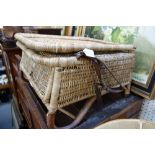 AN EARLY 20TH CENTURY WICKER FOLDING FISHING/GARDEN CHAIR with leather straps and feet and