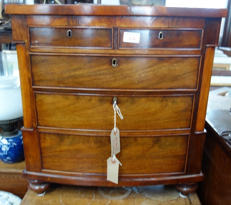 A VICTORIAN MINIATURE MAHOGANY BOWFRONT CHEST with two short and three long drawers, 52.5cm wide