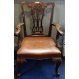A CHIPPENDALE STYLE MAHOGANY CARVER CHAIR with a brown leather seat