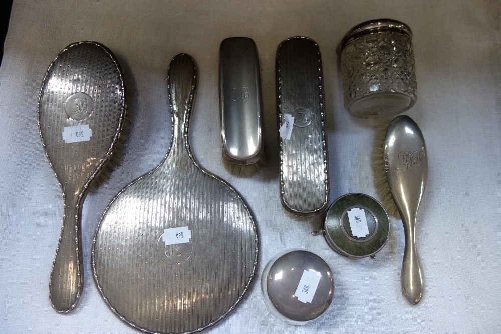 A SILVER BACKED BRUSH AND DRESSING SET