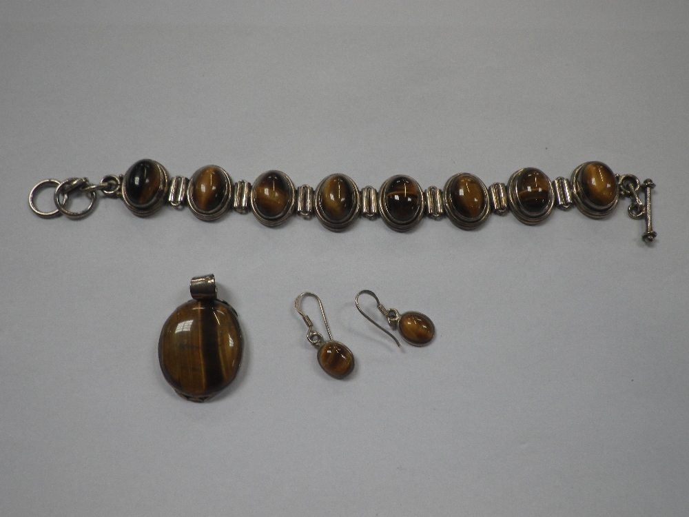 TIGERS EYE BRACELET, SET IN SILVER, together with en- suite pendant and earrings