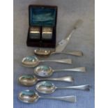 A PAIR OF BOXED SILVER NAPKIN RINGS, a collection of teaspoons and a butter knife
