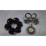 A CIRCULAR BROOCH, decorated with purple stones, together with a marcasite fob watch (2)