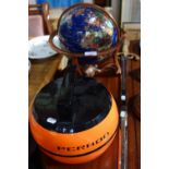 AN 'STONE SPECIMEN' WORLD GLOBE in bronzed stand and a Pernod ice bucket in the form of a curling