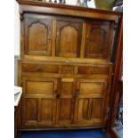 A GEORGE III OAK COURT CUPBOARD, above the straight cornice with two turned finials, below three