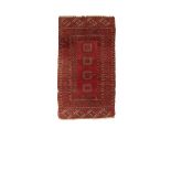 A NORTH WEST PERSIAN TRIBAL RUG, the brick red ground with a central rectangular panel worked with