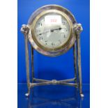 AN EDWARDIAN MANTEL CLOCK in a silver ram's head decorated case, 23cm high