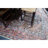 A LARGE BLUE GROUND PERSIAN RUG WITH PINK BORDERS AND ALL OVER FLORAL DESIGN 180 cm x 267 cm