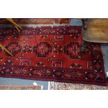 A RED GROUND PERSIAN RUNNER with geometric pattern, 81cm x 205cm (plus fringes)