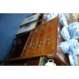 AN EDWARDIAN MAHOGANY FOUR DRAWER SHEET MUSIC CABINET, with folio rack beneath 53 cm wide