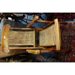 A VICTORIAN STEAMER CHAIR with caned seat and back