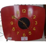 A VINTAGE 1960'S RED FORMICA WALL CLOCK with yellow numerals