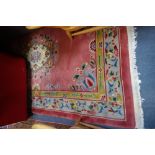 A PINK GROUND CHINESE RUG, 130cm x 202cm (plus fringes)