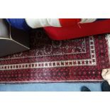 A RED GROUND PERSIAN RUG with allover geometric pattern, 104cm x 193cm (plus fringes)