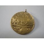 A GOLD EASTERN TOKEN, converted as a pendant, approx weight 10.5grams