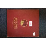 A VINTAGE RED STRAND STAMP ALBUM, containing world stamps and another similar (2)