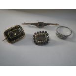 THREE MOURNING BROOCHES, together with a three stone paste ring (4)