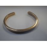 A TORQUE BANGLE, stamped "9ct", approx. 24grams total weight