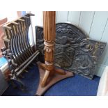 A 17TH CENTURY STYLE CAST IRON FIRE BACK with armorial, 75cm wide with a pair of wrought iron fire