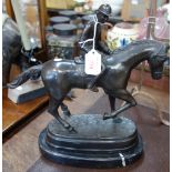 A PATINATED BRONZE SCULPTURE OF A RACE HORSE WITH JOCKEY UP, signed Marseille Debut, on black marble