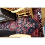 A BLUE GROUND PERSIAN RUG with large central medallion and red spandrels, 123cm x 200cm (plus