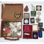 A COLLECTION OF CROWNS, military buttons, badges and sundries contained in a small leather case